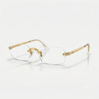Three-quarter perspective view of Ray-Ban by A$AP Rocky RB3928V rimless rectangular optical glasses in polished Arista Gold
